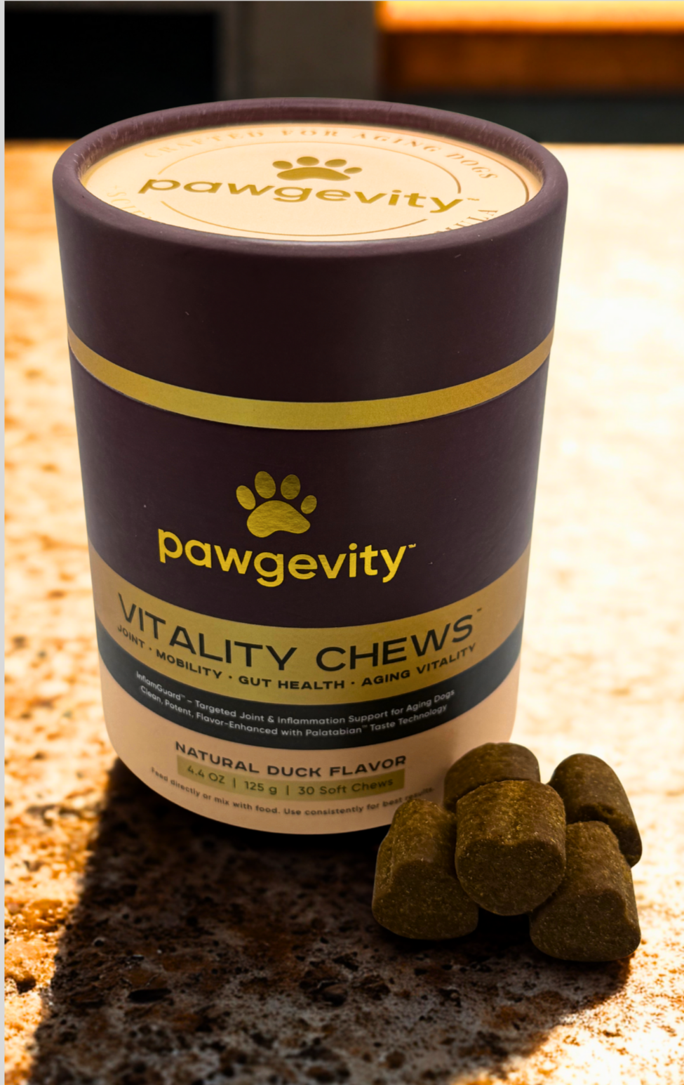Pawgevity Vitality Chews container with treats on a stone surface